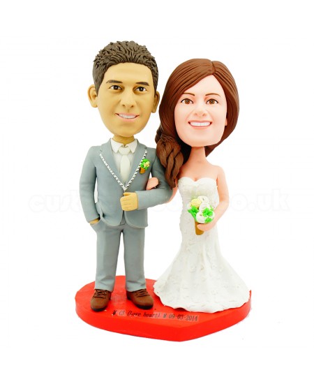 customised wedding cake topper bride holding grooms arm