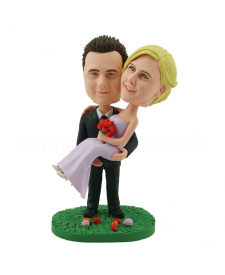 personalised wedding cake topper groom holding up bride