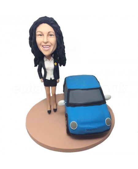 personlised female bobblehead beside a car