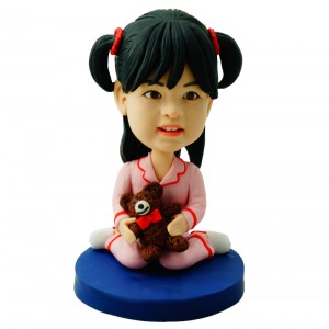 customised deary girl in pajamas carrying a bear doll