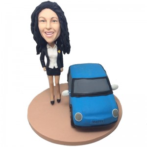 personlised female bobblehead beside a car