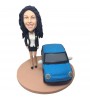 personlised female bobblehead beside a car
